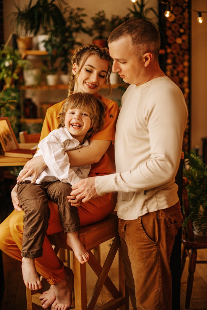 Smiling family enjoying quality time indoors, full of warmth and happiness.